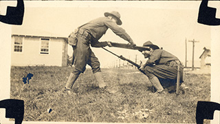 Two of Lawrence’s fellow soldiers, White and Aseltine, demonstrate close quarters combat techniques.