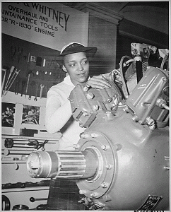 "Inspecting a Grumman Wildcat engine on display at the U.S. Naval Training School (WR) Bronx, NY, where she is a `boot' is WAVE Apprentice Seaman Frances Bates." 1945. 80-G-183373. National Archives Identifier: 520638