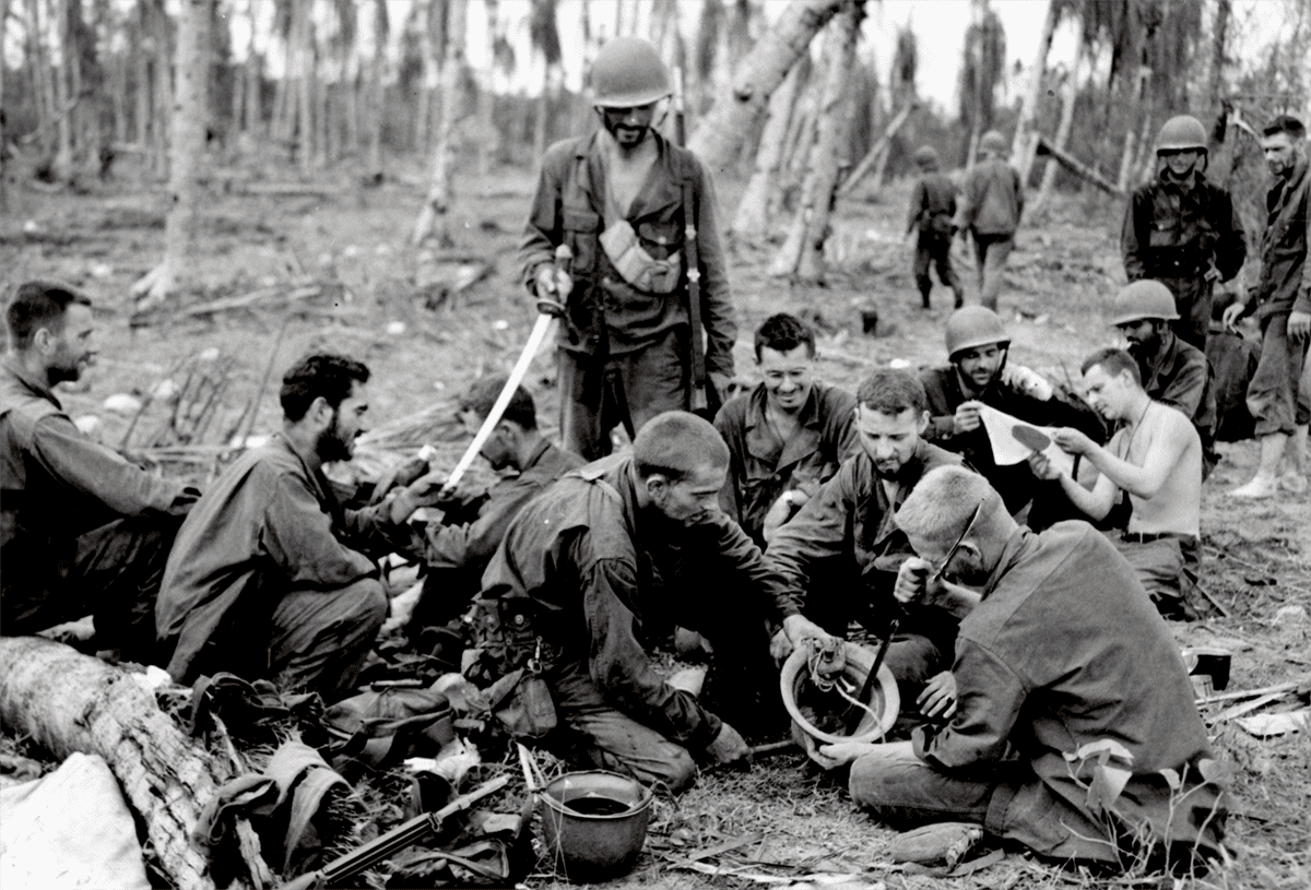 Soldiers reviewing souvenirs collected in the Pacific during WWII.