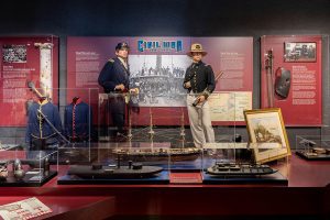 US Navy Civil War gallery display with two mannequin sailors among artifacts.