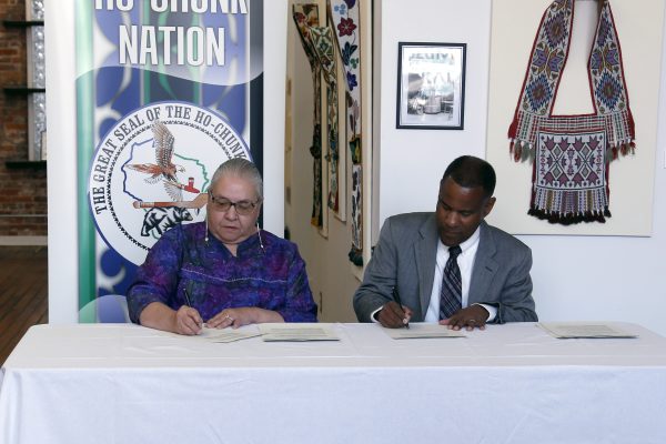 Photo taken at the memo of agreement signing between the Ho-Chunk Nation and the Wisconsin Veterans Museum, an educational activity of the WDVA. The Ho-Chunk Nation and the Wisconsin Veterans Museum staff will collaboratively gather oral histories from Ho-Chunk Nation veterans to be preserved by the Ho-Chunk Nation. A master copy of each interview will be included in the oral history collection of the Wisconsin Veterans Museum. The agreement ensures the stories of Ho-Chunk Nation veterans are treated with cultural sensitivity and respect as led by the Ho-Chunk Nation and that the Ho-Chunk Nation is represented in the military history of Wisconsin.