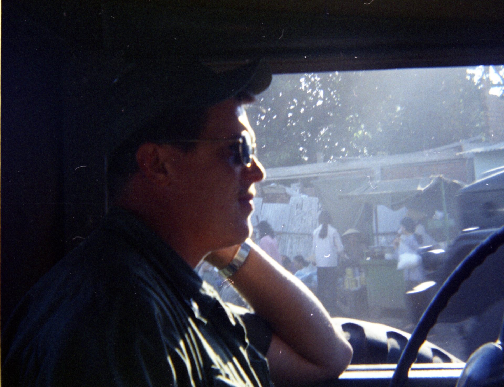 A photograph of Dennis Boyer seated in the driver's seat of a vehicle.