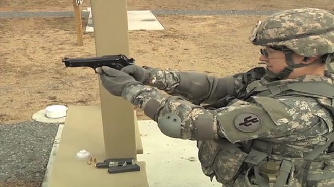 Photo of Williams aims a 9 mm pistol during the Best Warrior Competition.