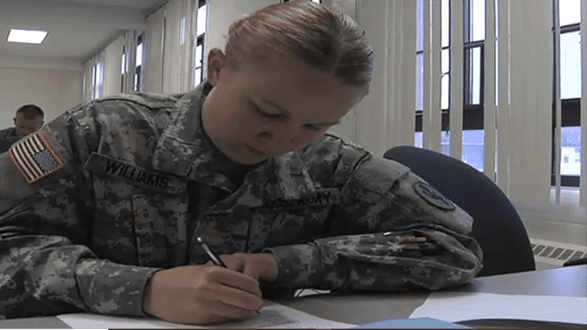 Photo of Williams writing an essay during the Best Warrior Competition.