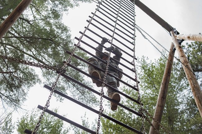 Photo of Williams climbing a chain ladder during the Best Warrior Competition.