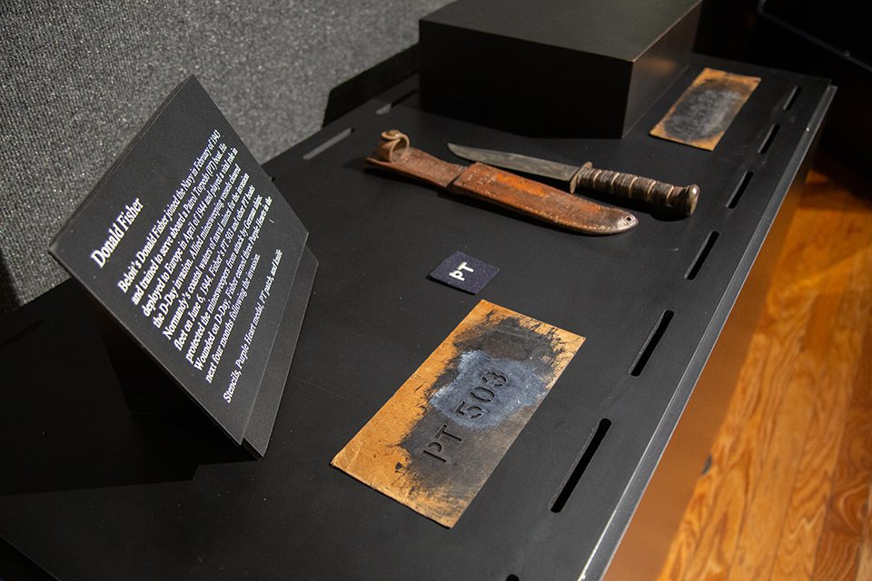 WWII artifacts of metal stencils "PT-503" and a knife and sheath.