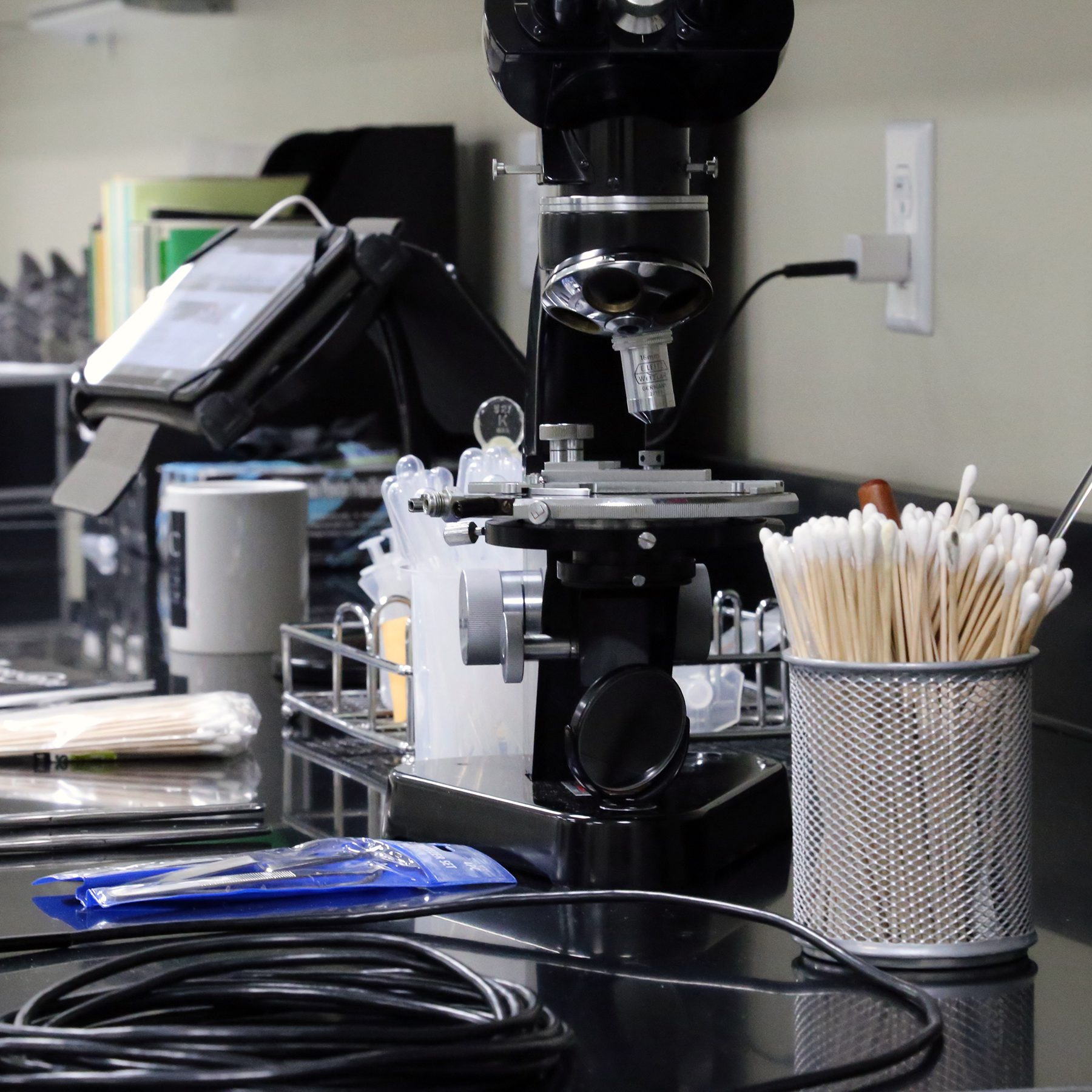Microscope and lab supplies on a workbench