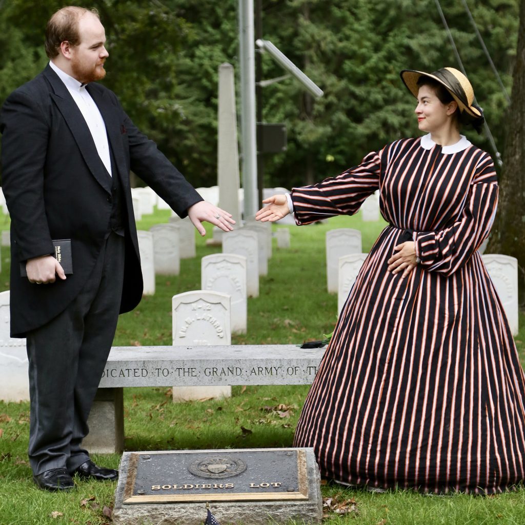 man and woman in 19thc dress holding hands