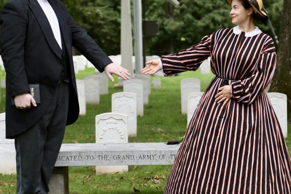 man and woman in 19thc dress holding hands