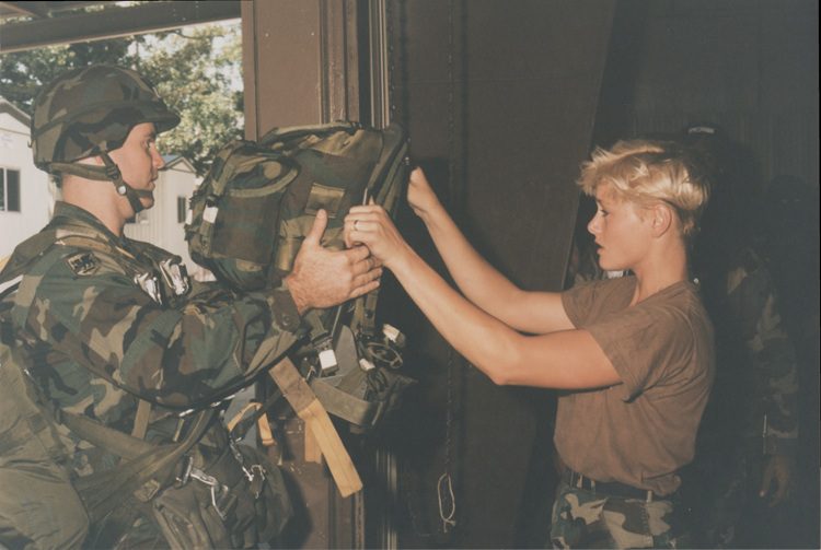 Jumpmaster inspecting the rigging of a paratrooper