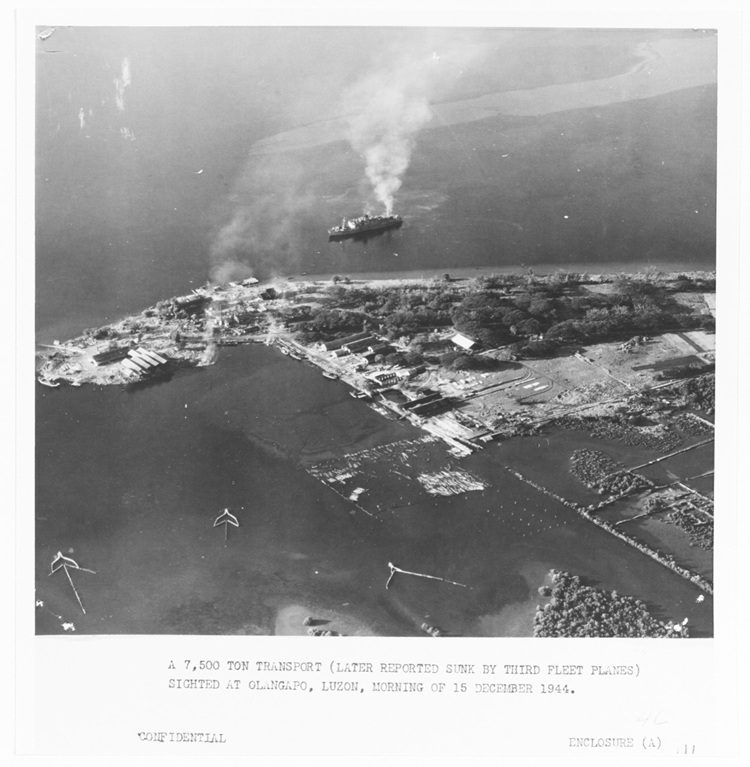 An aerial photo of a harbor and a ship in World War II.
