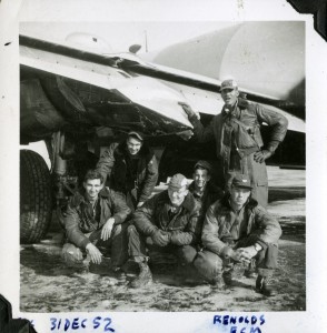 John Greening (center front)--seen in his yet-unpainted cap--poses with his crew in front of their B-29 in Okinawa. Photograph dated December 31, 1952.