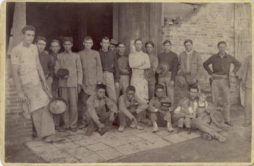 Soldiers and civilians in agroup . The United States soldiers wear a variety of uniform clothing,
